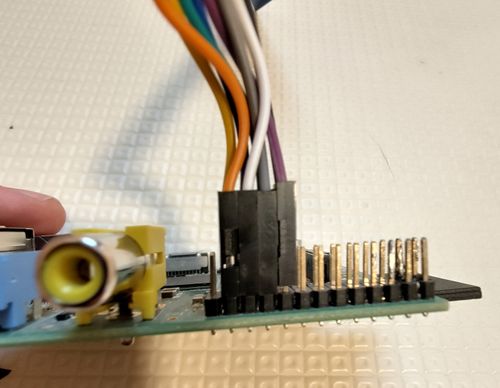Jumper cables from the card reader attaching to the Pi from the left